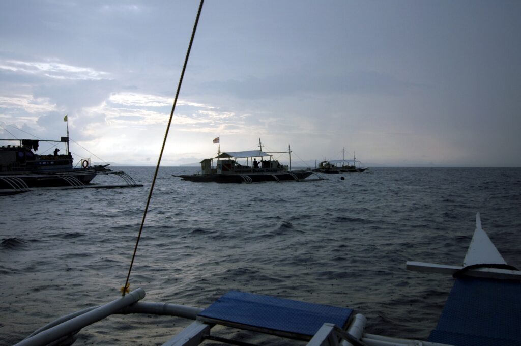 A boat travelling on the sea under grey morning skies over Monad Shoal
