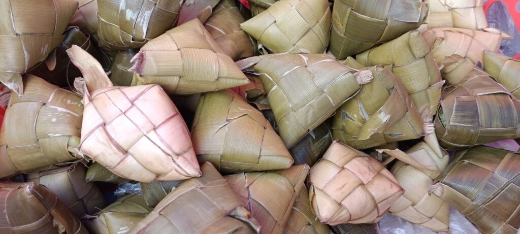A heap of rice cooked in woven coconut-leaf pouches, known as puso or hanging rice