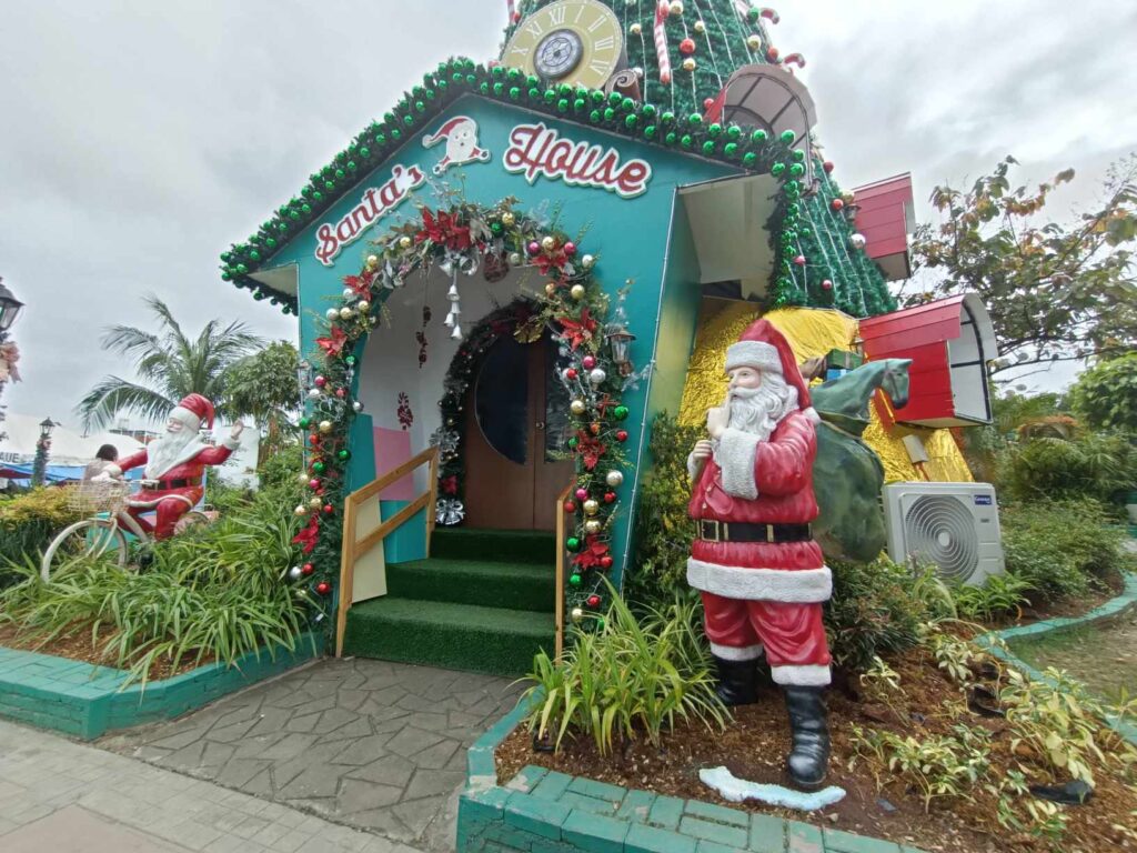 A decorated Santa's House with garlands and a Santa figure in Mandaue City, Cebu