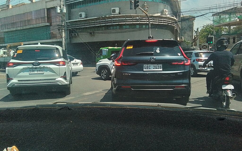 Cars queuing in heavy traffic on a street in Cebu seen from inside a vehicle
