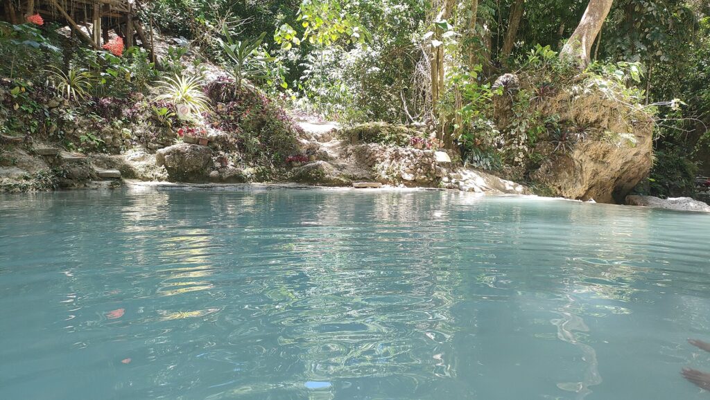 The milky turquoise swimming pool at the foot of the falls